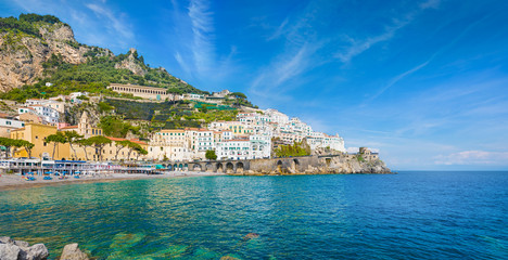 Wall Mural - Beautiful Amalfi on hills leading down to coast, comfortable beaches and azure sea on Amalfi Coast in Campania, Italy