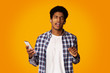 © Prostock-studio - African-American Guy Listening Music on Smartphone Online