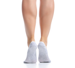 Female feet in gray no show socks on white background isolation