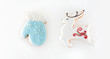 Christmas gingerbread isolated on white background. Set ginger biscuit cookies in shape of a blue mitten and a white reindeer.