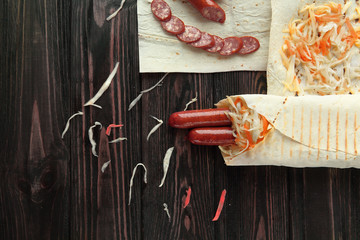 Wall Mural - sliced salami and Shawarma on wooden background .photo with copy space