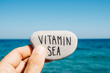 text vitamin sea in a stone on the beach