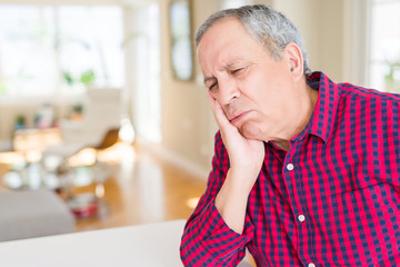 Sticker - Close up of handsome senior man at home thinking looking tired and bored with depression problems with crossed arms.