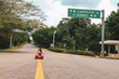 Girl sitting on the highway to mayan ruins of the ancient city in Uxmal, Yucatan, Mexico