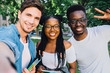 © Iryna - A group of young good looking multiethnic hipster friends students do selfie photo portrait in the park while summer morning. Education, lifestyle, leisure and technology concept.