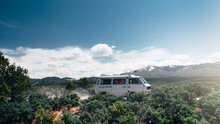 Camper Van Driving In The Mountains
