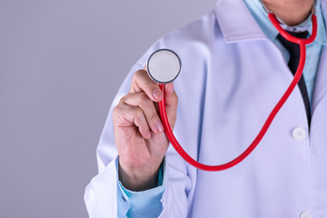 Medical doctor or physician in white gown uniform with stethoscope in hospital over white wall background. World Docter Day concept.