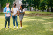 © Iryna - Full length of happy college multiethnic students talking together during break in sunny summer day on campus outdoor. Copy space. Different culture friendship concept