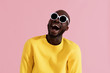 © puhhha - Fashion. Smiling black man in sunglasses colorful portrait