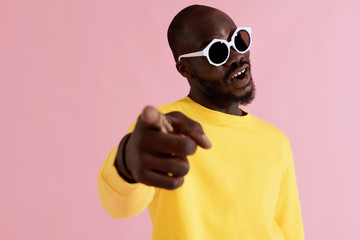 Fashion. Happy black man in sunglasses and sweatshirt portrait