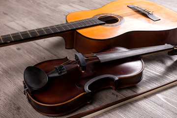 Classical violin and guitar on wooden background. Traditional musical instruments