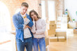 © Krakenimages.com - Beautiful young couple moving to a new house thinking looking tired and bored with depression problems with crossed arms.