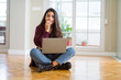 © Krakenimages.com - Young woman using computer laptop sitting on the floor looking stressed and nervous with hands on mouth biting nails. Anxiety problem.