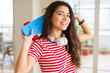 © Krakenimages.com - Beautiful skater woman smiling friendly standing with skateboard