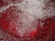 Аir bubbles in the water on a red background.
