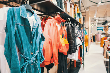 Blurred big sales on Black Friday. On sale at a clothing store in a modern shopping mall. Beautifully laid out things on hangers. Basic background for design