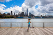 © Tandem Stock - A woman runs along the Hudson River Park Pier 45 near downtown Manhattan in New York City.