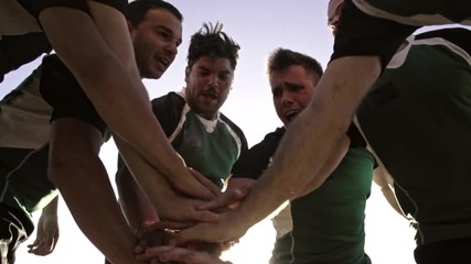 Wall Mural - Rugby team putting their hands together before the match. Rugby players cheering and ready to win.