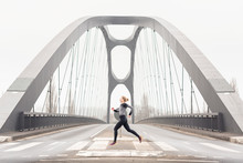 Side View Of Woman Running On Bridge