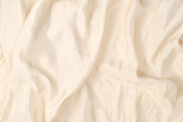  Soft smooth beige silk fabric background. Fabric texture.
