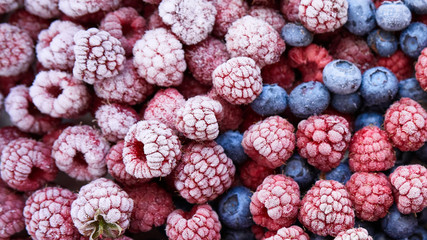 Fototapete - Background of frozen berries. Top view of raspberries and blueberries.