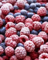 Fototapete - Background of frozen berries. Top view of raspberries and blueberries.