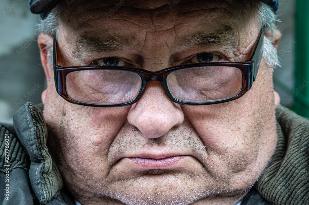 Brooding Angry Brooding and angry old grandfather with glasses looks in front of him ...