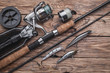 Fishing tackle for catching predatory fish. Wobblers, spinning, reel, fishing line on the wooden background