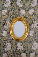 Oval Golden Picture Frame On Wallpaper With Art Nouveau Floral Design