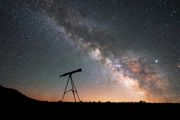 Wall Mural - Silhouette of a telescope at the starry night and bright milky way galaxy.