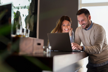 Couple surfing the net on a laptop computer