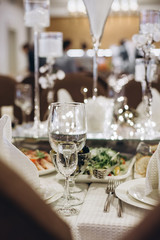 Wall Mural - Wine glasses and glasses on the server table.Luxurious elegant dinner at the table in the restaurant. Holiday table decoration