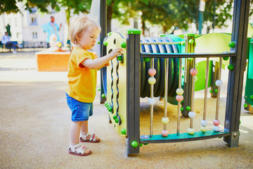 Adorable little girl on playground on a sunny day