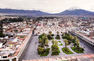 Canvas Print - Aerial drone view of Arequipa main square and cathedral church, with the Misti volcano as background.