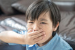 asian little boy get cold and blow her nose, Sick child in room under blanket blowing his nose