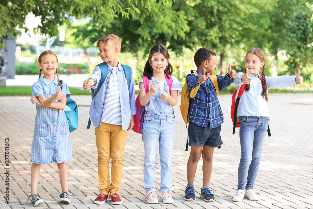 Group of cute little pupils outdoors
