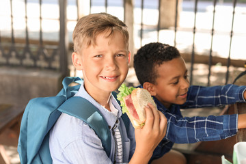 Poster - Little children having lunch outdoors