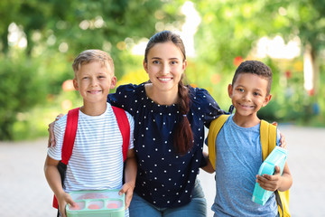 Sticker - Portrait of mother and her little sons with school lunch outdoors