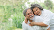 Happy love Elderly couple smile face , Senior couple old man and senior woman relaxing hug in a forest