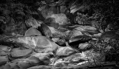 Wall Mural - Devil's Pool or Babinda Boulders is a mystical natural pool at the confluence of three streams among a group of boulders near Babinda, Queensland, Australia. Black and White photography. -Image. 