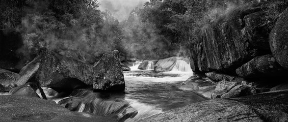 Wall Mural - Devil's Pool or Babinda Boulders is a mystical natural pool at the confluence of three streams among a group of boulders near Babinda, Queensland, Australia. Black and White photography. -Image. 