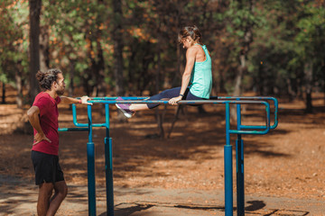 Wall Mural - Exercising on parallel bar in the park