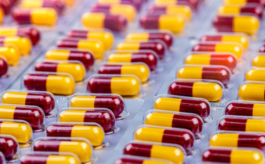 Wall Mural - Red-yellow capsule in blister pack. Antibiotic capsule pills. Antimicrobial drug resistance. Penicillin drug for treatment infection. Amoxicillin medicine for kill bacteria. Pharmaceutical industry.