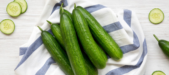 Fresh raw green cucumbers, top view. Flat lay, from above, overhead.