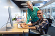 © wavebreak3 - Male and female executives working together on computer at desk in office