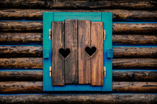 Architecture Detail - Old Wooden Window Shutters With Carved Hearts.