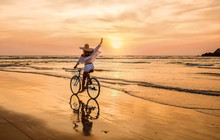 Happiness Woman Traveler With Her Bicycle Rides On Sea Coastline