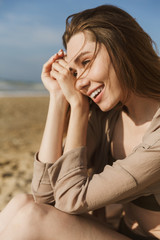 Wall Mural - Happy smiling pleased amazing woman posing outdoors at the sea beach.