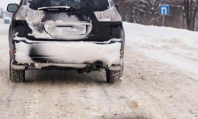 Wall Mural - Cars with winter tires on snow-covered road