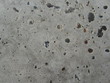 Concrete floor with small stones. Close-up. Gray concrete grunge background. Stone texture.